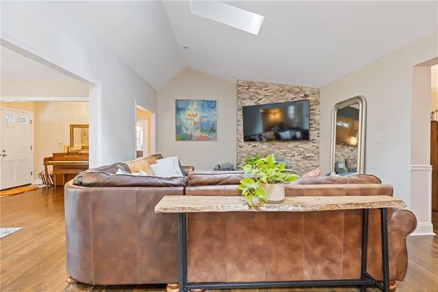 a living room with fireplace furniture and a window