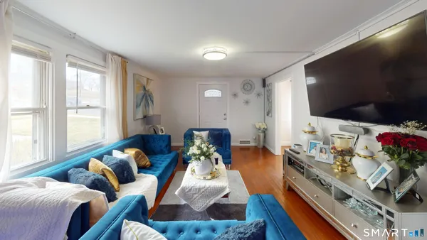 a living room with furniture and a flat screen tv