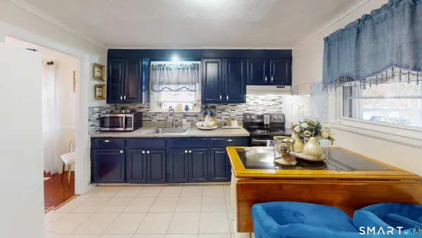 a kitchen with stainless steel appliances granite countertop a sink dishwasher stove and refrigerator