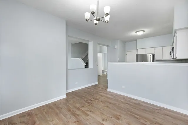 a view of a kitchen with wooden floor and a ceiling fan