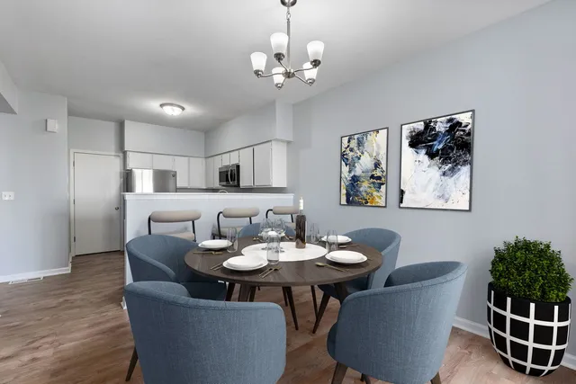 a view of a dining room with furniture and wooden floor