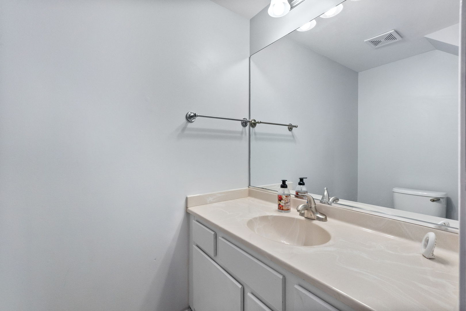 199 North Oakhurst Drive, Unit 199 Aurora, IL 60504 - Photo 16 of 25 a bathroom with a sink and a mirror