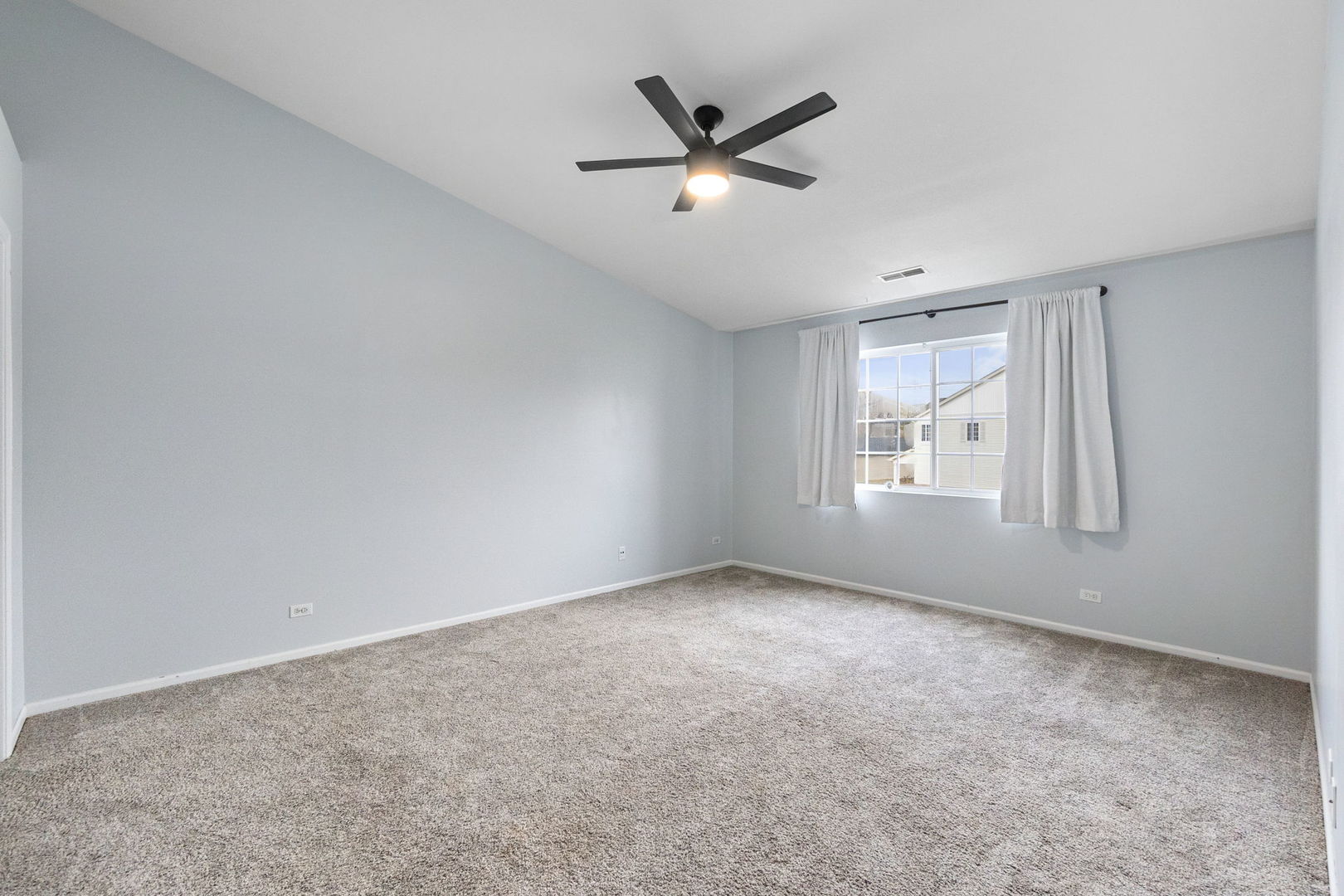 199 North Oakhurst Drive, Unit 199 Aurora, IL 60504 - Photo 21 of 25 an empty room with windows and fan