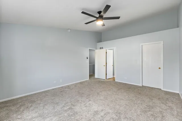an empty room with a ceiling fan and a ceiling fan