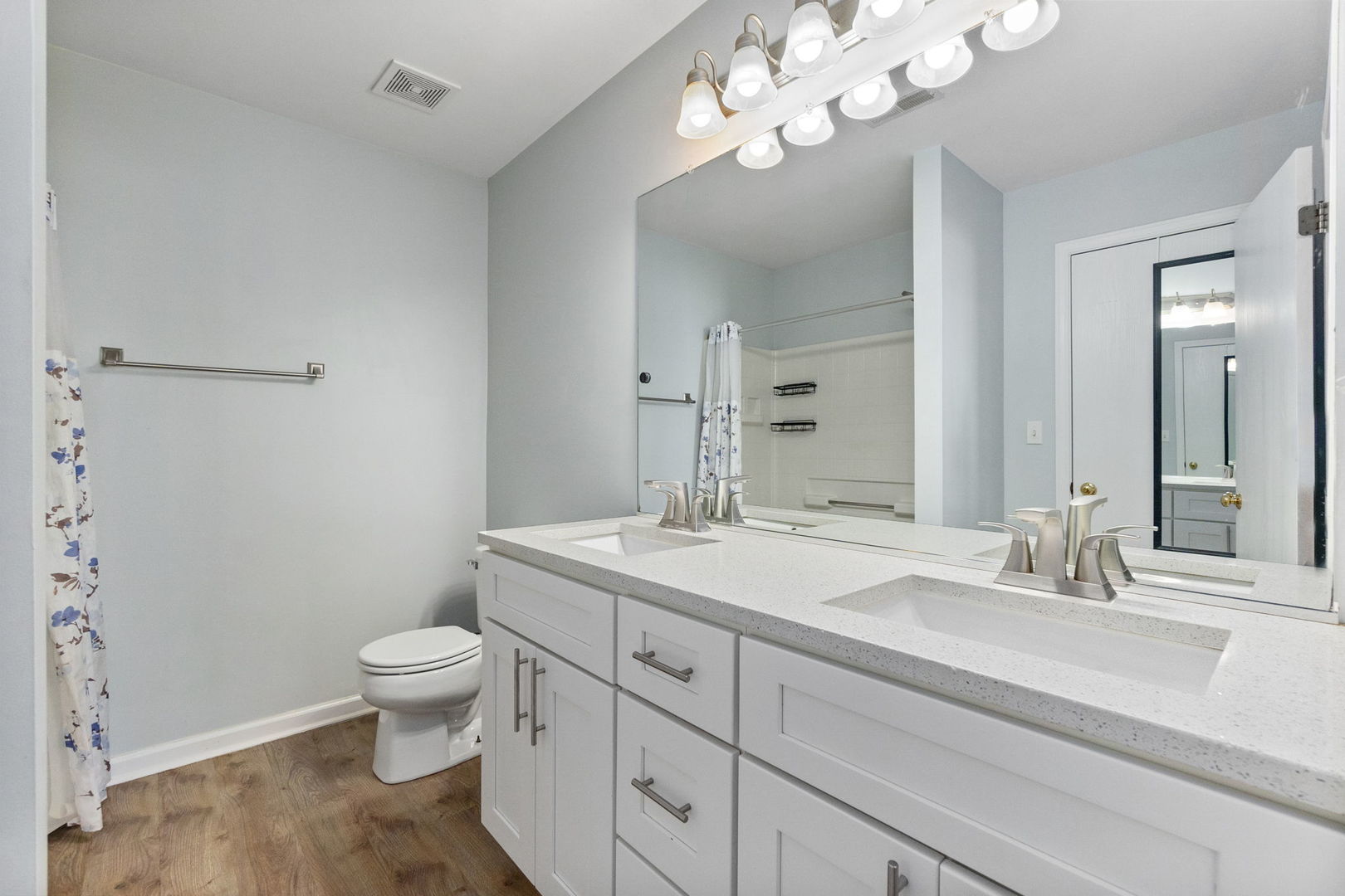 199 North Oakhurst Drive, Unit 199 Aurora, IL 60504 - Photo 24 of 25 a bathroom with a granite countertop sink a toilet and a mirror