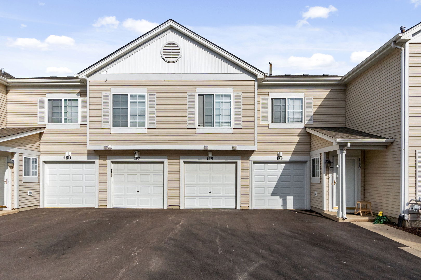 199 North Oakhurst Drive, Unit 199 Aurora, IL 60504 - Photo 25 of 25 a front view of a house with a garage