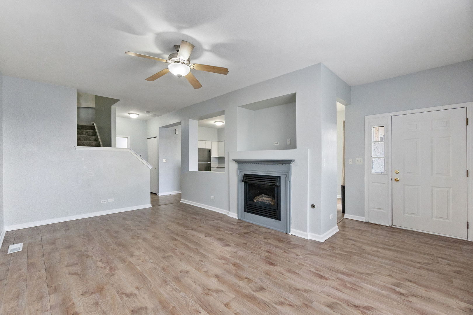199 North Oakhurst Drive, Unit 199 Aurora, IL 60504 - Photo 6 of 25 a view of empty room with wooden floor and fan