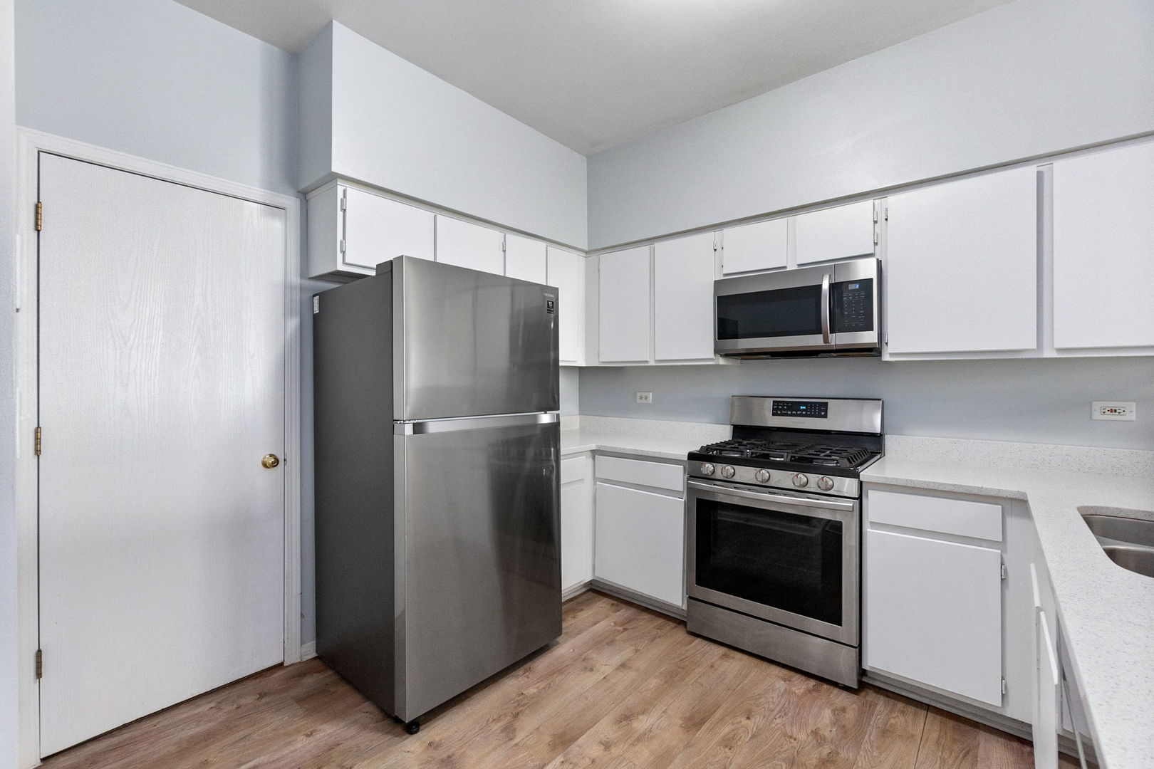 199 North Oakhurst Drive, Unit 199 Aurora, IL 60504 - Photo 8 of 25 a kitchen with stainless steel appliances a refrigerator stove and microwave