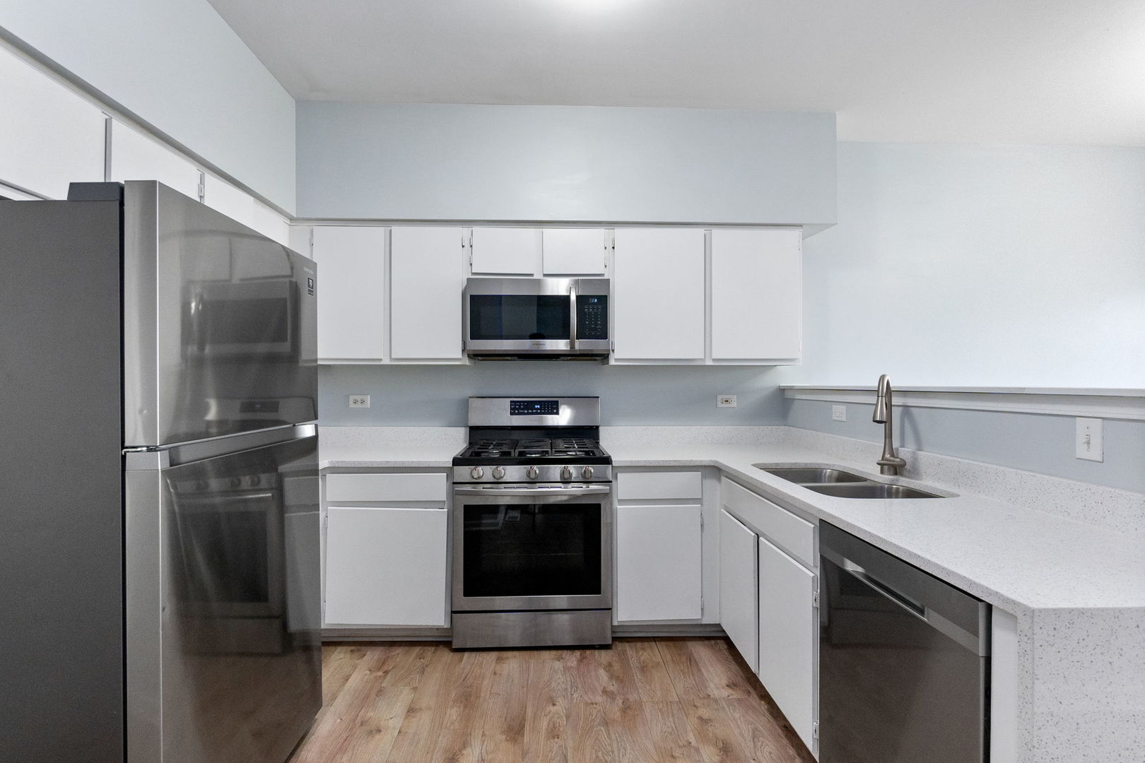 199 North Oakhurst Drive, Unit 199 Aurora, IL 60504 - Photo 9 of 25 a kitchen with a sink stove and refrigerator