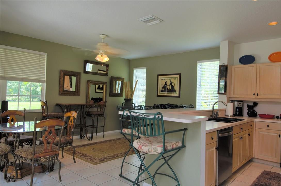 17401 Sunset Drive Southwest Ranches, FL 33331 - Photo 13 of 45 a kitchen with a table chairs and a stove