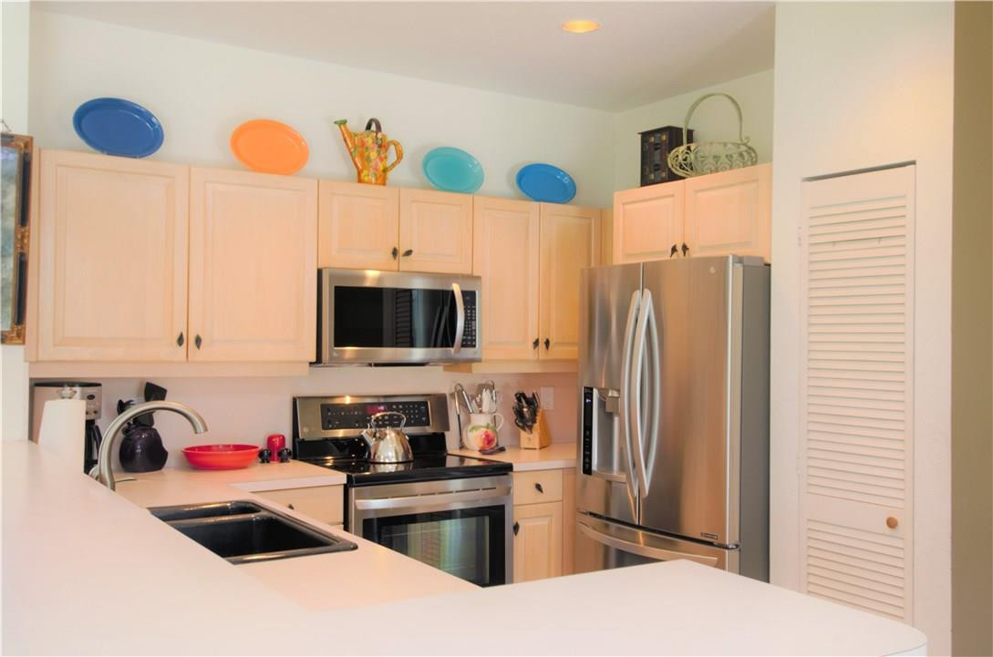 17401 Sunset Drive Southwest Ranches, FL 33331 - Photo 15 of 45 a kitchen with stainless steel appliances a refrigerator a sink a stove and a microwave