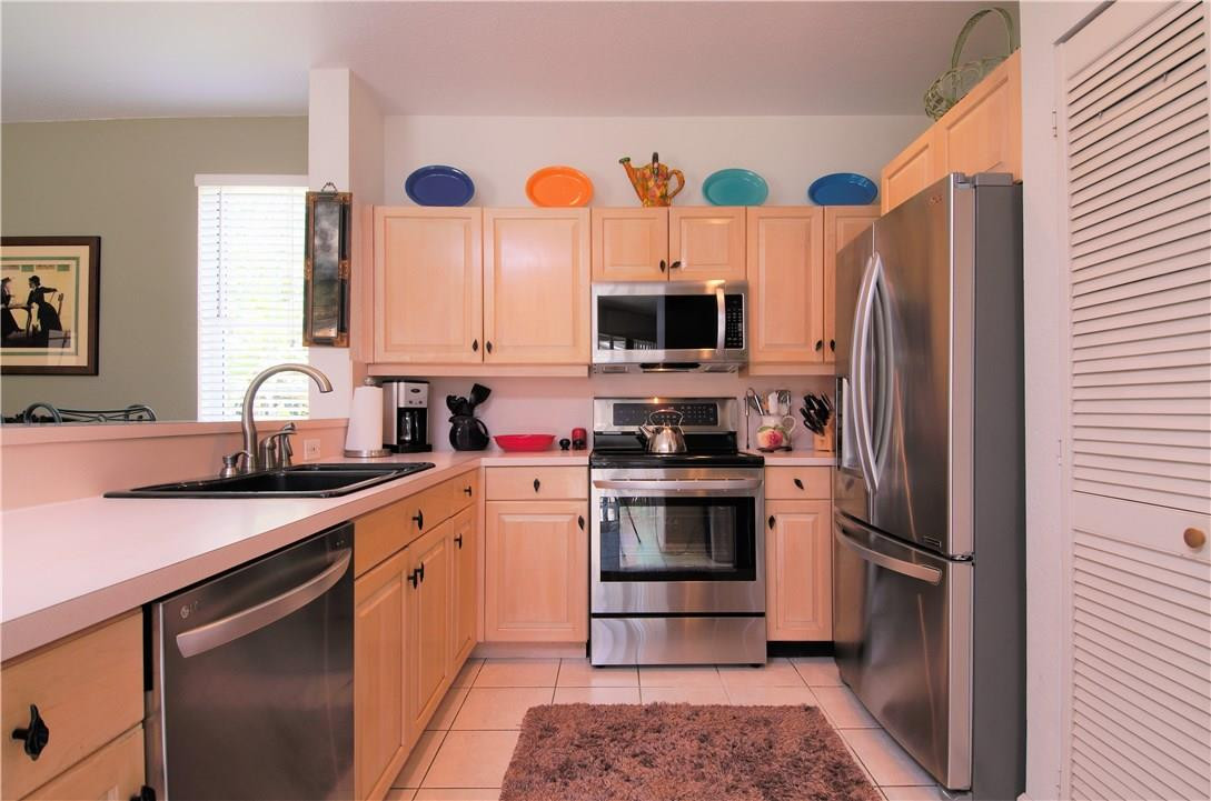 17401 Sunset Drive Southwest Ranches, FL 33331 - Photo 17 of 45 a kitchen with stainless steel appliances a sink a stove a refrigerator and cabinets