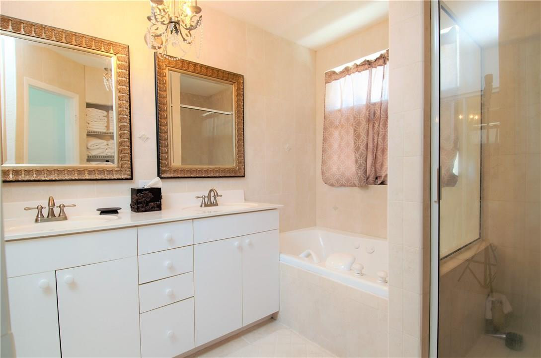 17401 Sunset Drive Southwest Ranches, FL 33331 - Photo 23 of 45 a bathroom with a tub sink and mirror