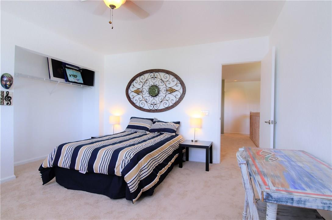 17401 Sunset Drive Southwest Ranches, FL 33331 - Photo 27 of 45 a bedroom with a bed and a chandelier