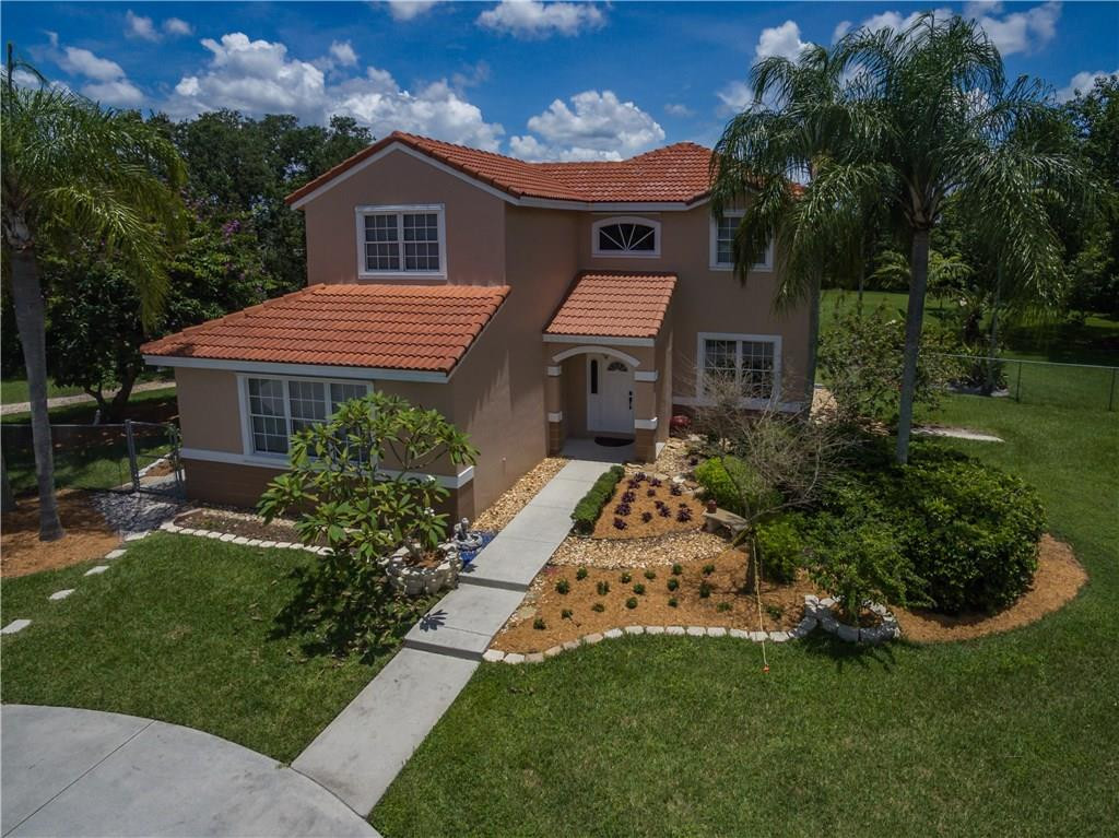 17401 Sunset Drive Southwest Ranches, FL 33331 - Photo 3 of 45 a front view of a house with a garden