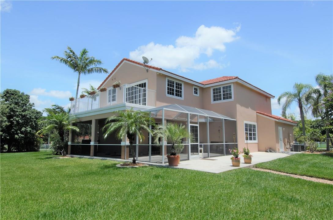 17401 Sunset Drive Southwest Ranches, FL 33331 - Photo 37 of 45 a front view of a house with a yard table and chairs