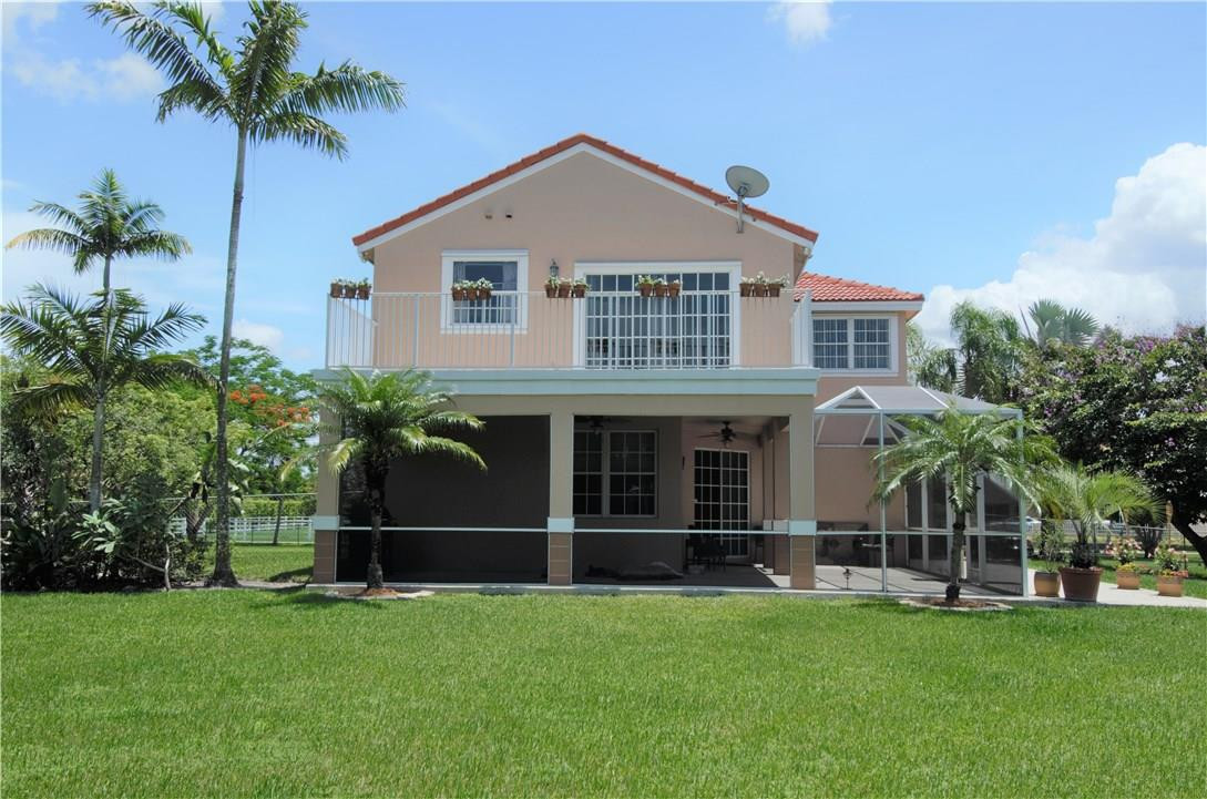 17401 Sunset Drive Southwest Ranches, FL 33331 - Photo 38 of 45 a front view of a house with a garden