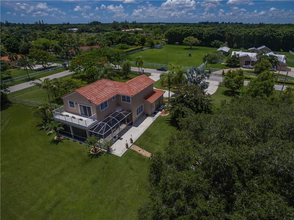 17401 Sunset Drive Southwest Ranches, FL 33331 - Photo 40 of 45 an aerial view of a house with outdoor space and mountain view in back