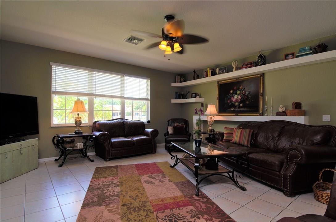 17401 Sunset Drive Southwest Ranches, FL 33331 - Photo 7 of 45 a living room with furniture a chandelier and a window