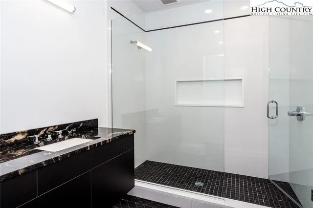 a view of a room with wooden floor