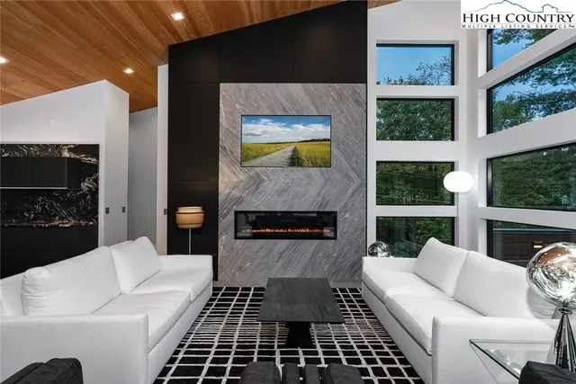 a living room with furniture a rug and a fireplace