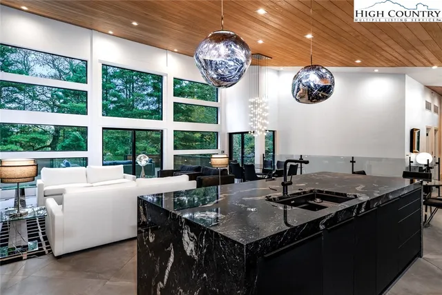 a very nice looking dining room with furniture and a large window