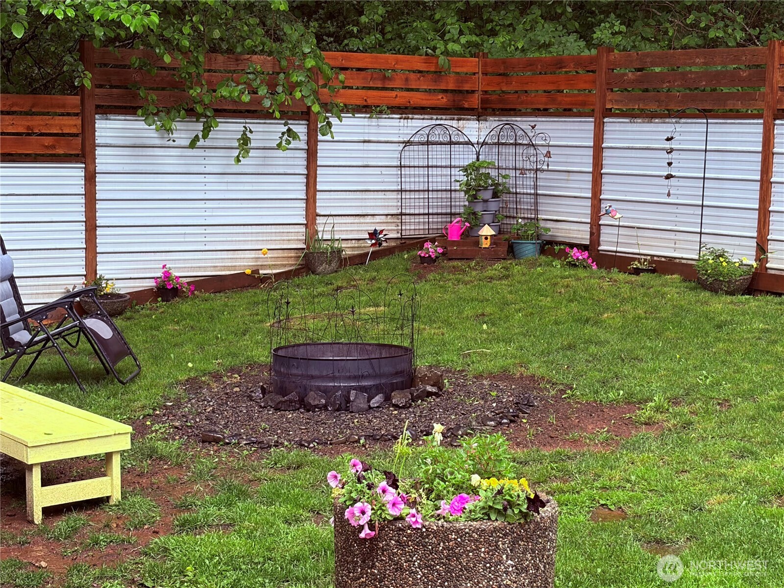 690 North Summit Road McCleary, WA 98557 - Photo 6 of 40 a view of a backyard with plants and a bench