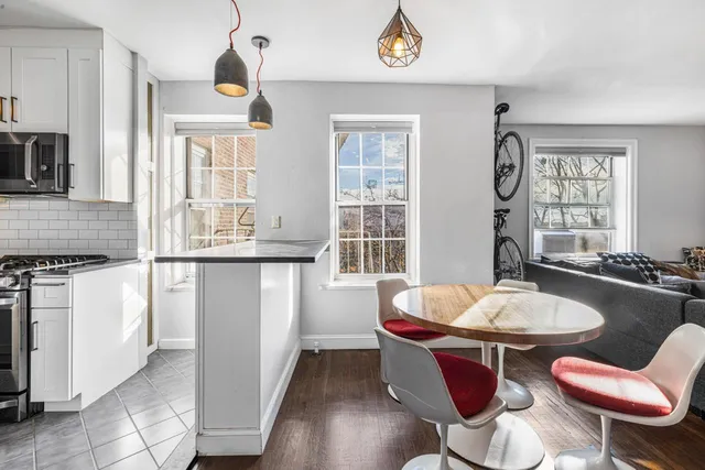 a dining room with wooden floor and breakfast area