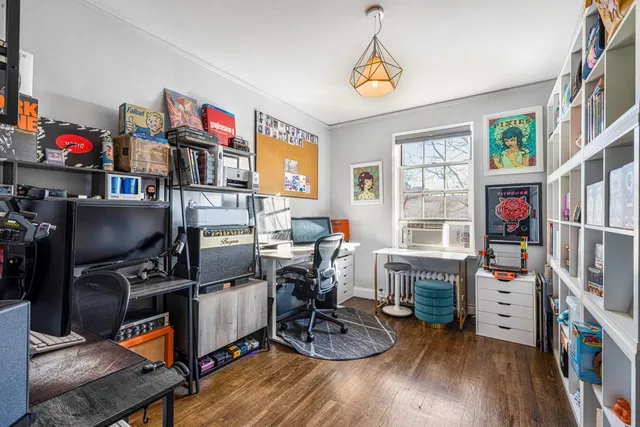 a view of a workspace with furniture and a window