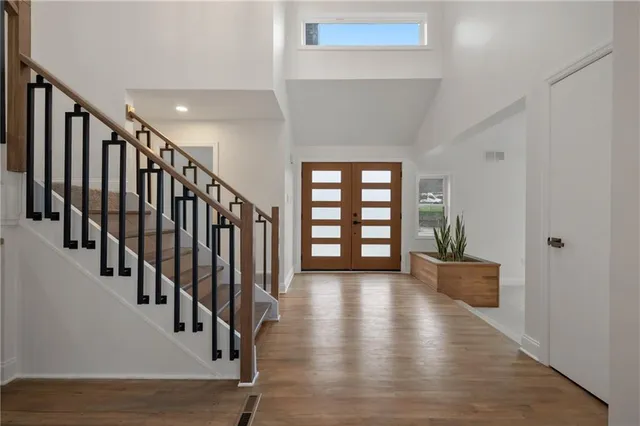 a view of a living room with a floor to ceiling window and potted plant