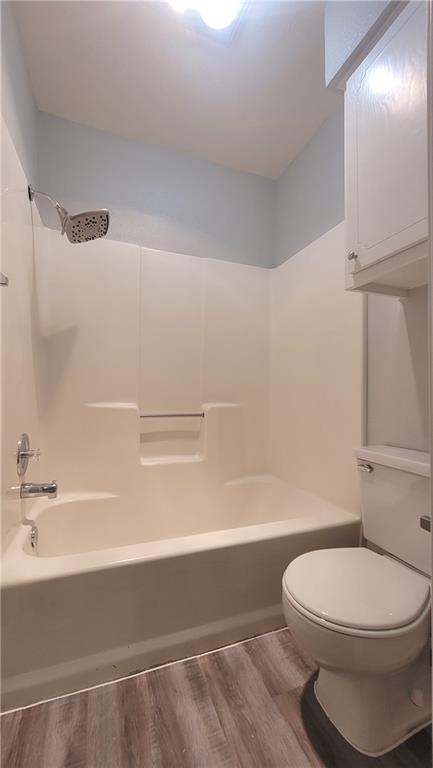15405 Spring Hill Lane, Unit B Pflugerville, TX 78660 - Photo 11 of 18 a bathroom with a toilet a sink and bathtub