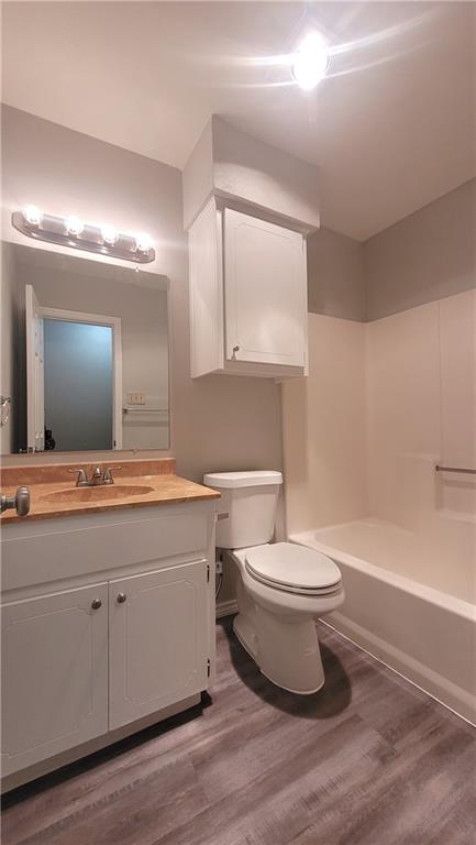 15405 Spring Hill Lane, Unit B Pflugerville, TX 78660 - Photo 15 of 18 a bathroom with a toilet a sink a mirror and bathtub
