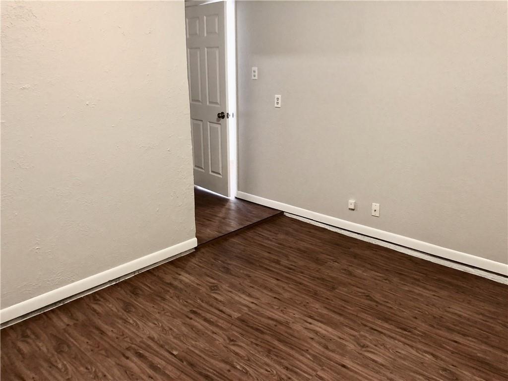 15405 Spring Hill Lane, Unit B Pflugerville, TX 78660 - Photo 17 of 18 a view of an empty room with wooden floor