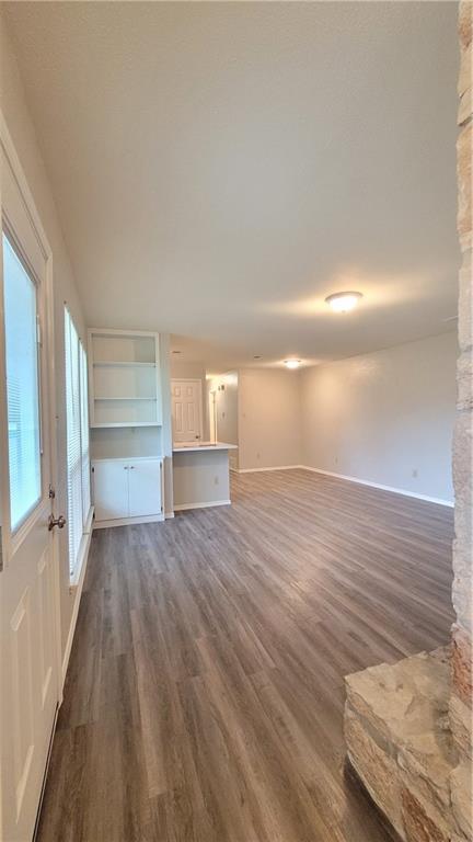 15405 Spring Hill Lane, Unit B Pflugerville, TX 78660 - Photo 3 of 18 a view of empty room with wooden floor