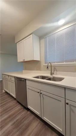 a kitchen with sink and cabinets