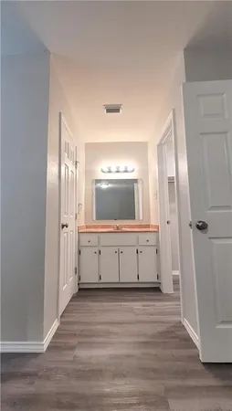 a view of a hallway with wooden floor