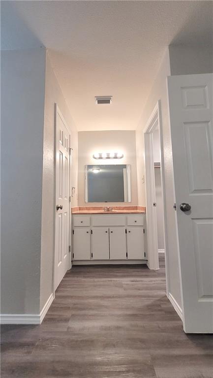 15405 Spring Hill Lane, Unit B Pflugerville, TX 78660 - Photo 10 of 18 a view of a hallway with wooden floor