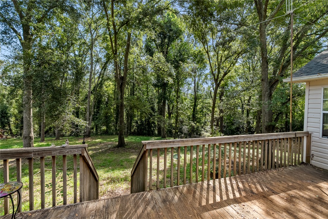 306 Lakewood Drive Anderson, SC 29621 - Photo 11 of 17 This spacious wooden deck overlooks a tranquil, tree-lined yard, perfect for outdoor enjoyment.