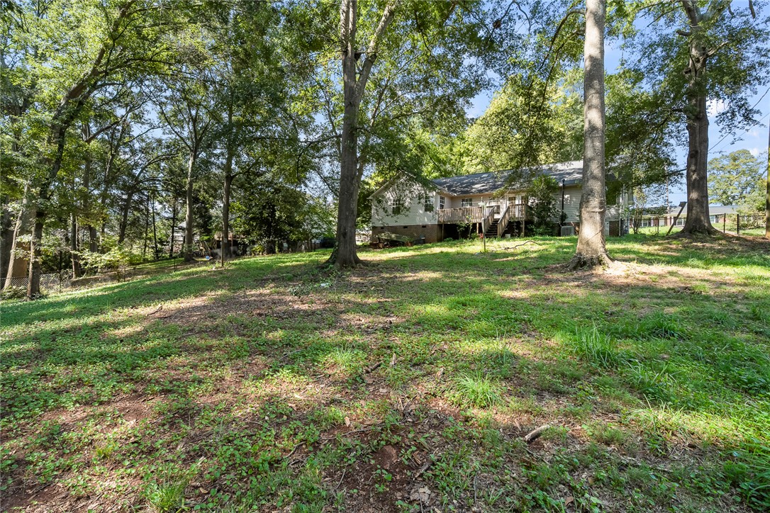 306 Lakewood Drive Anderson, SC 29621 - Photo 12 of 17 This verdant expanse offers a private outdoor retreat with ample space for relaxation.