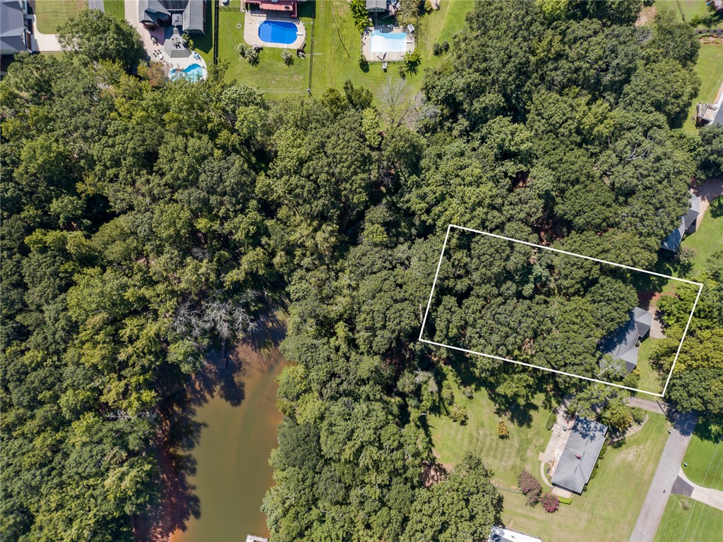 306 Lakewood Drive Anderson, SC 29621 - Photo 15 of 17 This aerial view showcases a verdant, wooded lot with convenient waterfront access and nearby community amenities.