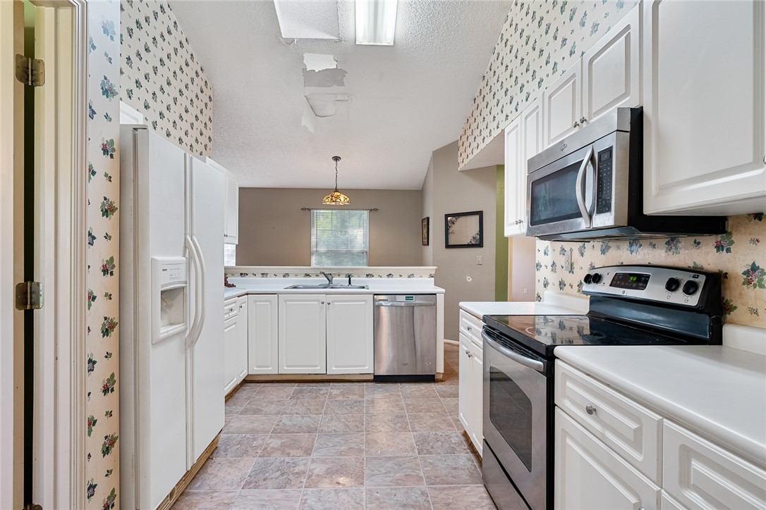 306 Lakewood Drive Anderson, SC 29621 - Photo 7 of 17 This spacious kitchen offers ample cabinet space and modern appliances for everyday living.