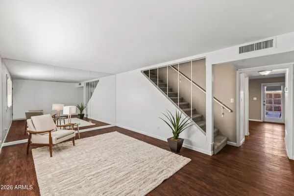 a living room with furniture and wooden floor