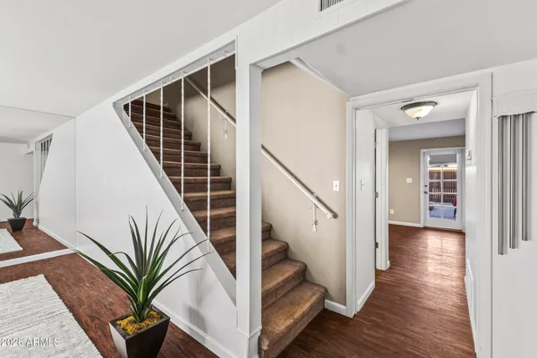 a view of entryway with wooden floor and stairs