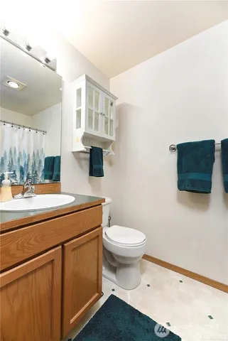 a bathroom with a sink a toilet and a mirror