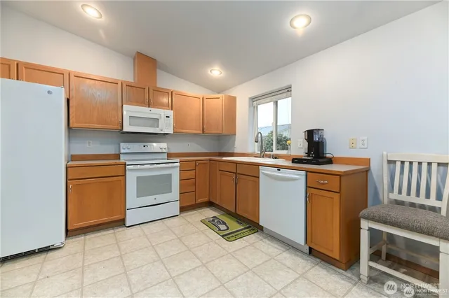 a kitchen with a sink appliances and cabinets