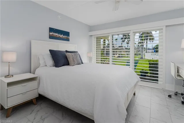 a bedroom with a bed and a night stand