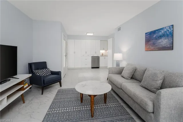 a living room with furniture and a rug