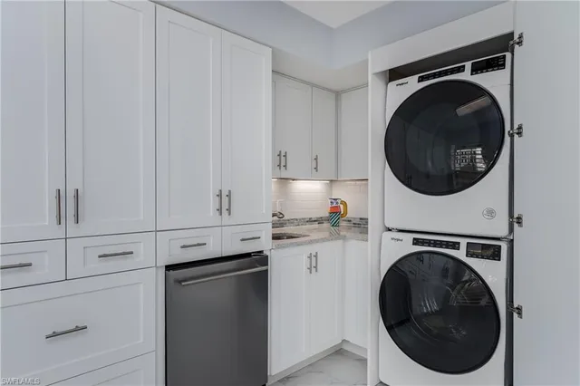 a utility room with sink dryer and washer