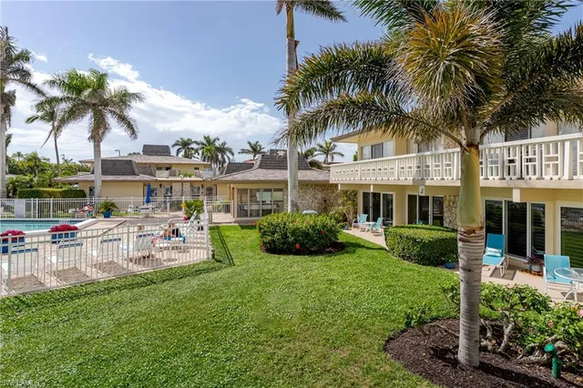 a front view of house with yard and outdoor seating
