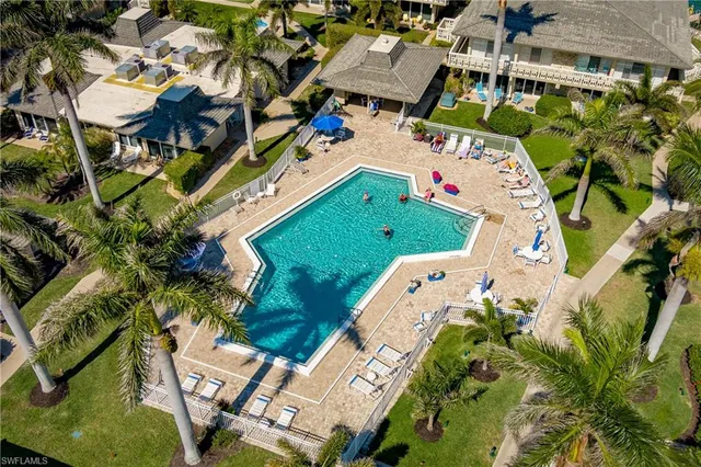 an aerial view of a house with a yard and trees